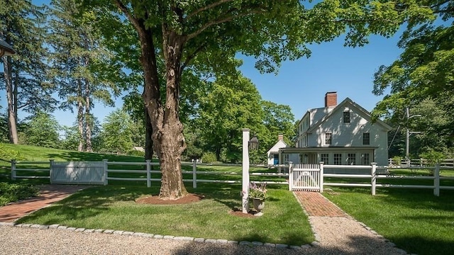 view of home's community with a gate, a yard, and a fenced front yard
