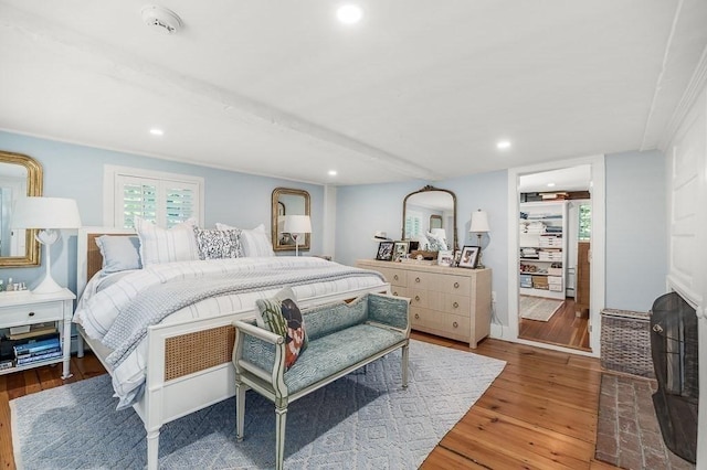 bedroom featuring multiple windows, wood finished floors, and recessed lighting