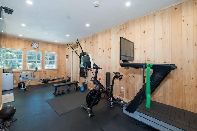 workout room with baseboards, wooden walls, and recessed lighting