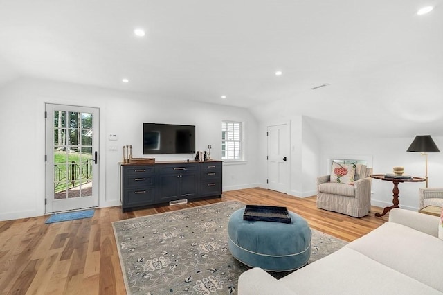 living area with lofted ceiling, baseboards, recessed lighting, and light wood-style floors