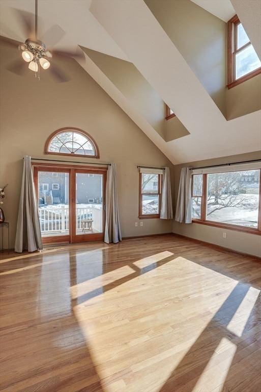 bonus room with ceiling fan, light hardwood / wood-style floors, and high vaulted ceiling