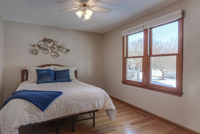 bedroom featuring wood-type flooring and ceiling fan