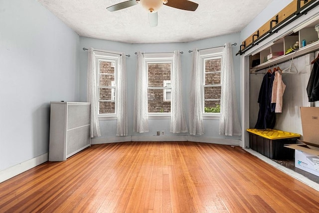 26 Enfield Rd, Winthrop, MA 02152 - spare room featuring radiator, ceiling fan, light wood-style floors, and a textured ceiling