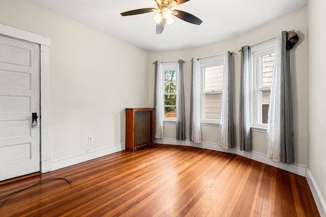 26 Enfield Rd, Winthrop, MA 02152 - unfurnished room featuring light wood-style floors, ceiling fan, and radiator