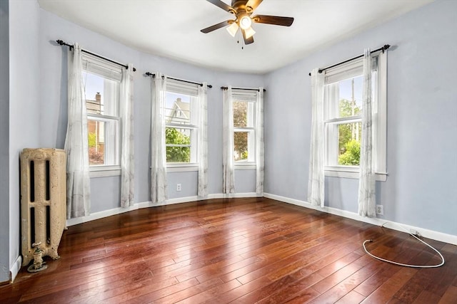 26 Enfield Rd, Winthrop, MA 02152 - unfurnished room with radiator heating unit, healthy amount of natural light, ceiling fan, and wood-type flooring
