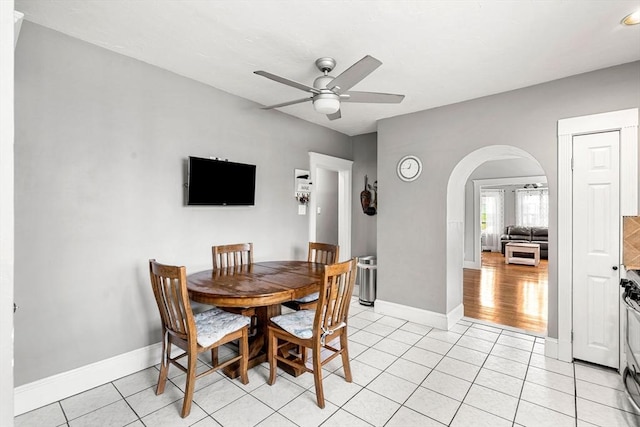 26 Enfield Rd, Winthrop, MA 02152 - dining space featuring a ceiling fan, arched walkways, and light tile patterned floors