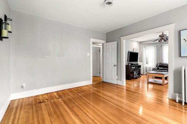 26 Enfield Rd, Winthrop, MA 02152 - living room with radiator heating unit, light wood-style flooring, and a ceiling fan
