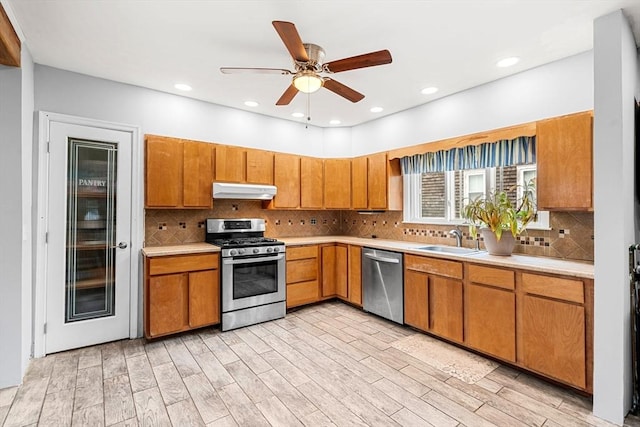 26 Enfield Rd, Winthrop, MA 02152 - kitchen featuring stainless steel appliances, under cabinet range hood, light countertops, a ceiling fan, and brown cabinets