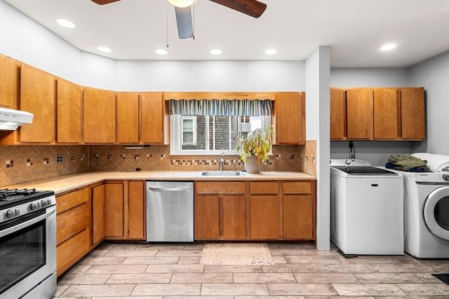 26 Enfield Rd, Winthrop, MA 02152 - kitchen featuring appliances with stainless steel finishes, washer and dryer, range hood, light countertops, and backsplash