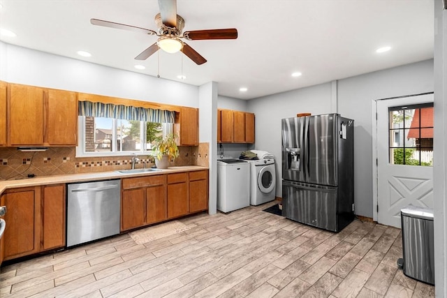 26 Enfield Rd, Winthrop, MA 02152 - kitchen featuring washing machine and clothes dryer, appliances with stainless steel finishes, brown cabinets, ceiling fan, and light countertops