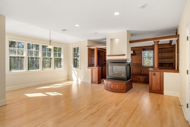 unfurnished living room featuring baseboards, recessed lighting, and light wood-type flooring