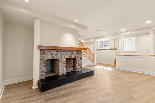 unfurnished living room featuring a fireplace, recessed lighting, baseboards, and light wood-style floors