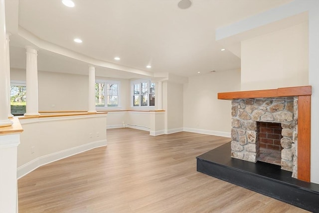 unfurnished living room with wood finished floors, a healthy amount of sunlight, and recessed lighting