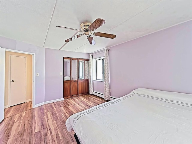 unfurnished bedroom with baseboards, ceiling fan, and wood finished floors