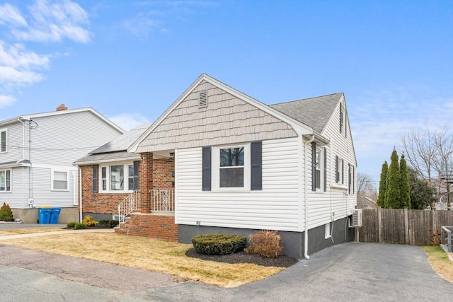 view of front of home with an AC wall unit