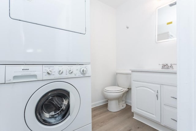 22 Frenier Ave Unit 9, Attleboro, MA 02703 - half bathroom with stacked washer and clothes dryer, wood finished floors, toilet, vanity, and baseboards