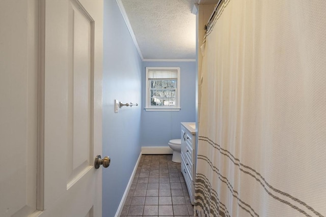 bathroom with crown molding, vanity, a textured ceiling, tile patterned floors, and toilet