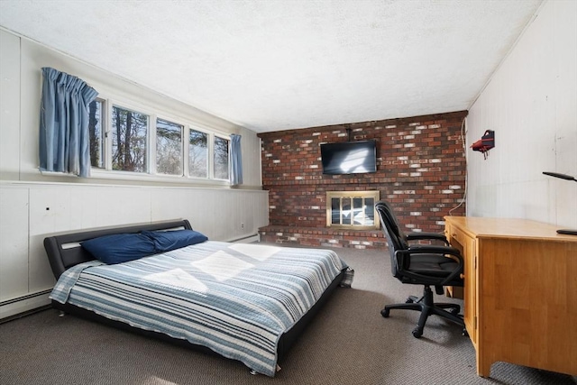 carpeted bedroom featuring baseboard heating, a fireplace, and a textured ceiling