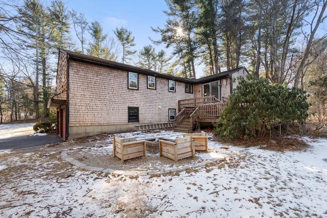 view of snow covered back of property