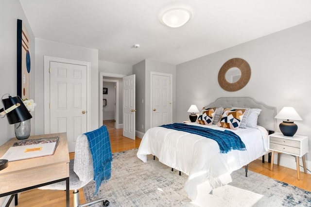 bedroom featuring baseboards and wood finished floors