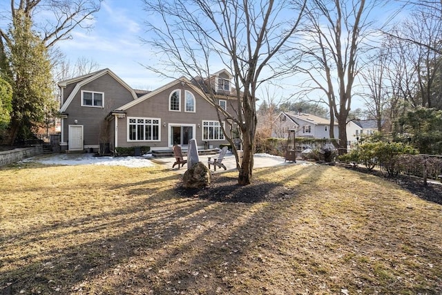 back of house featuring entry steps, a patio area, and a gambrel roof