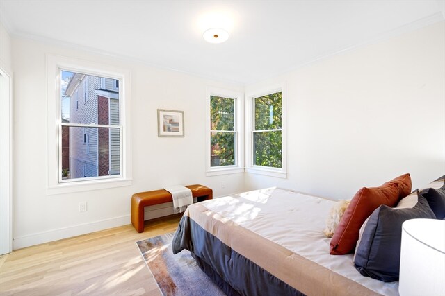 bedroom featuring light hardwood / wood-style floors and ornamental molding