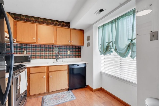 42 Nassau Dr Unit 42, Springfield, MA 01129 - kitchen with appliances with stainless steel finishes, a sink, tasteful backsplash, light wood-style floors, and light countertops