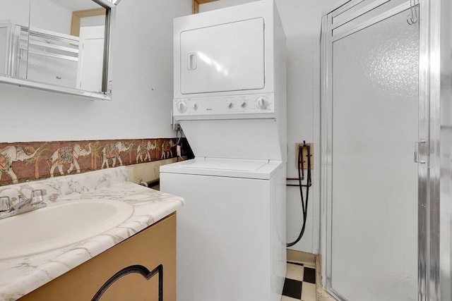 42 Nassau Dr Unit 42, Springfield, MA 01129 - laundry room featuring stacked washer and clothes dryer and light flooring