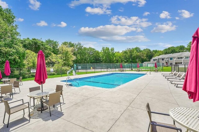 42 Nassau Dr Unit 42, Springfield, MA 01129 - community pool featuring a patio area and view of wooded area