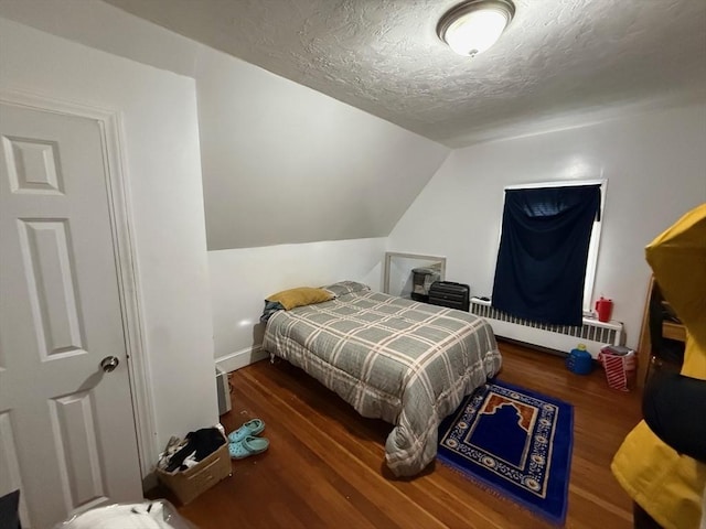 2 Stanton St, Boston, MA 02124 - bedroom with wood finished floors, a textured ceiling, lofted ceiling, a baseboard heating unit, and baseboards