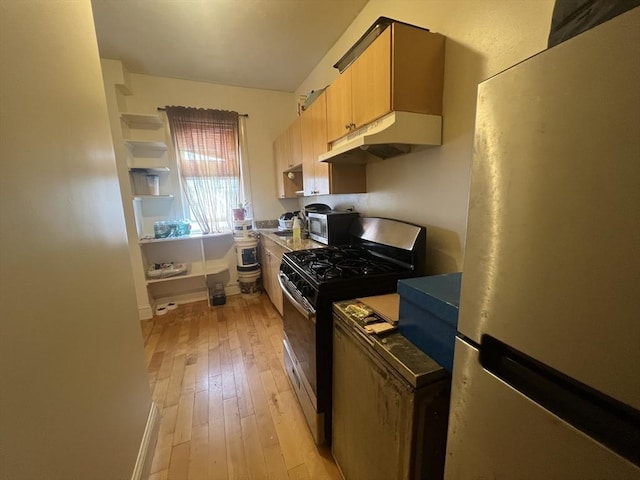 2 Stanton St, Boston, MA 02124 - kitchen with stainless steel appliances, under cabinet range hood, light wood-style floors, baseboards, and open shelves