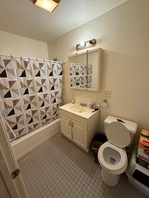 2 Stanton St, Boston, MA 02124 - bathroom featuring toilet, tile patterned floors, shower / bath combo, and vanity