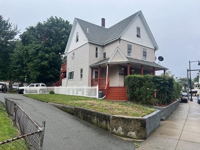 2 Stanton St, Boston, MA 02124 - view of front of property featuring a porch, a chimney, and roof with shingles
