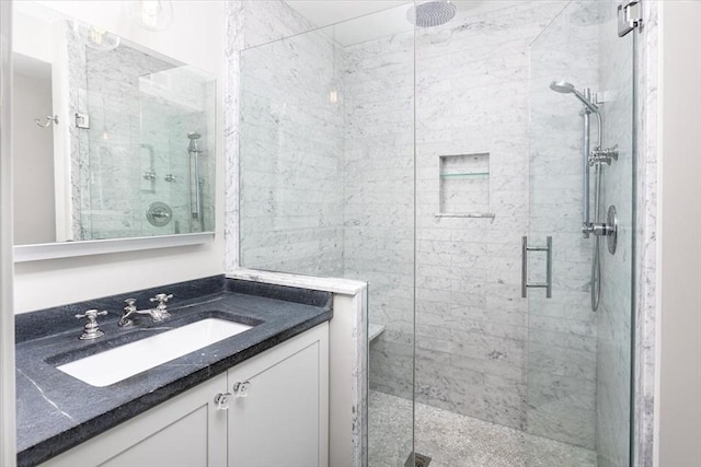 bathroom featuring vanity and a shower stall