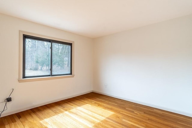 unfurnished room featuring light wood-style floors and baseboards