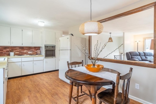 dining space with light wood-type flooring