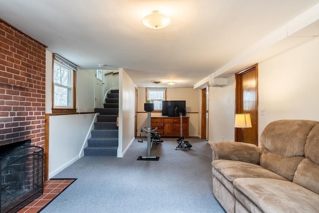 living area featuring stairway, a fireplace, and baseboards