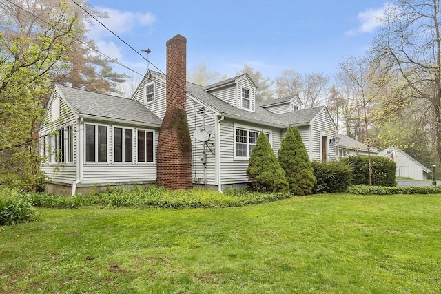 view of property exterior featuring a yard, a chimney, and a shingled roof