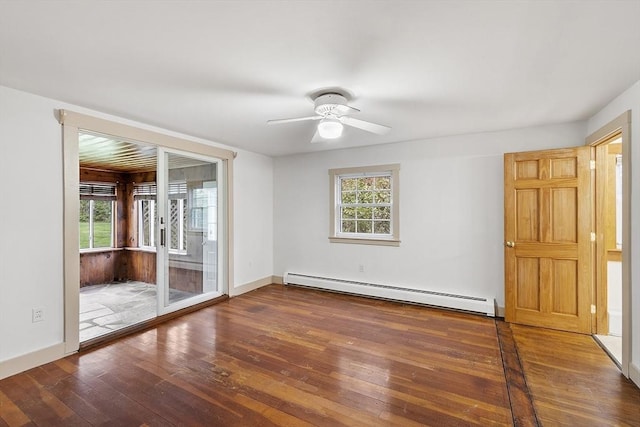 empty room featuring a baseboard heating unit, ceiling fan, baseboards, and wood-type flooring