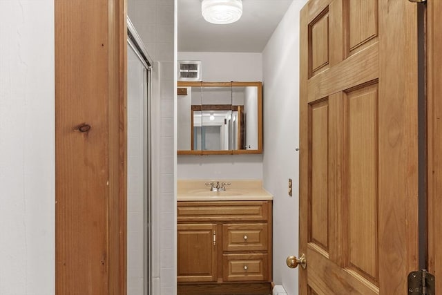 full bath with a shower with shower door and vanity