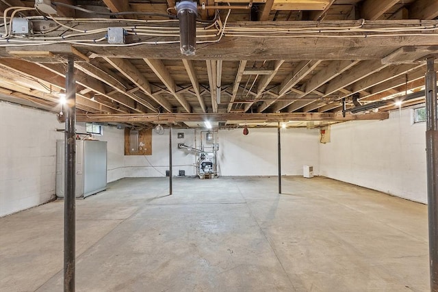 below grade area with concrete block wall and electric panel