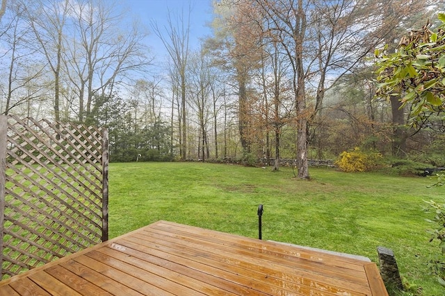 wooden terrace featuring a yard