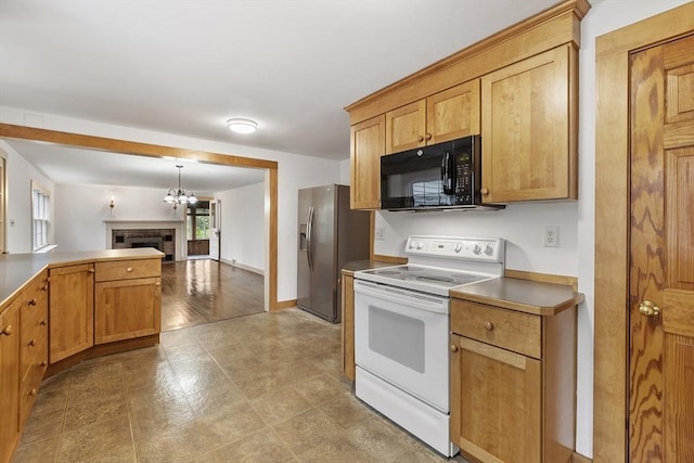kitchen with stainless steel refrigerator with ice dispenser, black microwave, open floor plan, white range with electric cooktop, and a notable chandelier
