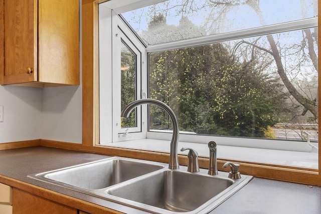 room details with brown cabinetry and a sink