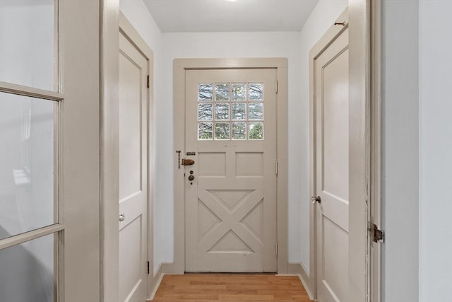 entryway featuring light wood-style floors and baseboards