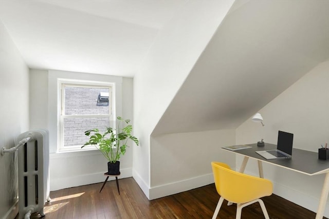 office area featuring baseboards, wood finished floors, and vaulted ceiling