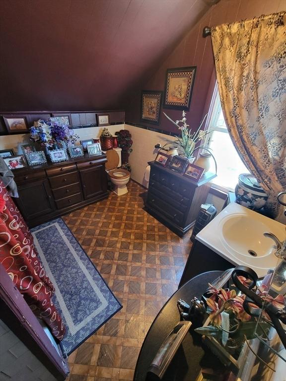 interior space featuring lofted ceiling and a sink