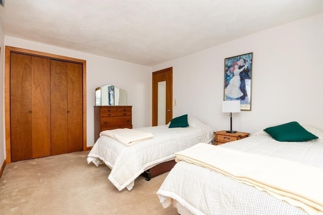 carpeted bedroom featuring a closet