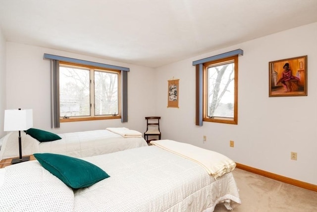 carpeted bedroom with baseboards