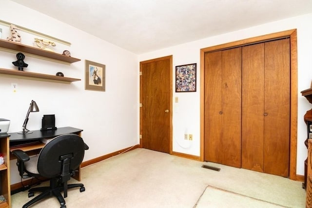 carpeted home office featuring visible vents and baseboards